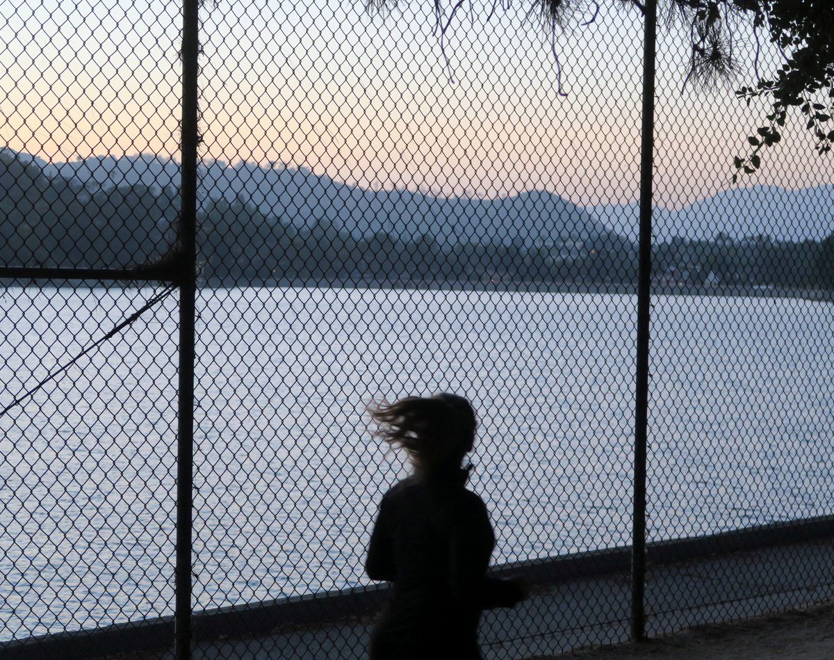 Runner in front of Silver Lake Reservoir Fence
